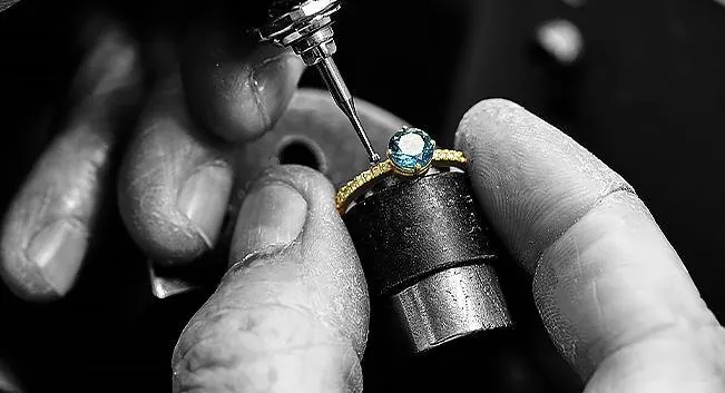 Jeweller setting a stone in a ring